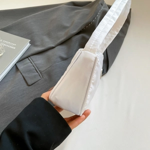 Detailed side view showing the triangular structure and silky nylon texture of the white bag