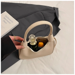Detailed interior of woven hobo bag showing large capacity for essentials and cosmetics