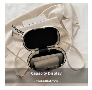 Internal capacity of cream bucket bag showing fit for smartphone and wallet