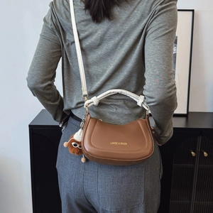 French retro brown leather saddle bag with white handle and cute plush charm