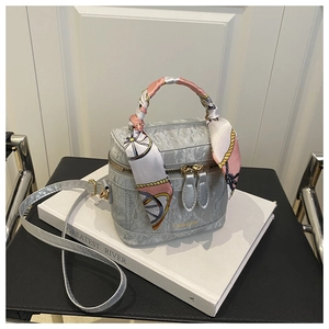 Detail view of silver marble textured handbag with silk scarf handle and dual zipper closure