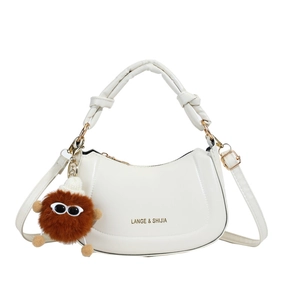 Minimalist creamy white half-moon shoulder bag with unique knot handle and cute pompom charm