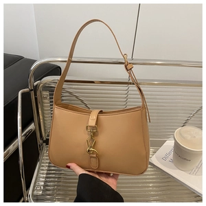 Close-up of khaki hobo bag featuring matte leather, gold clasp, and adjustable shoulder strap