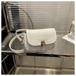Close-up of white crossbody bag with lychee texture and gold square snap lock