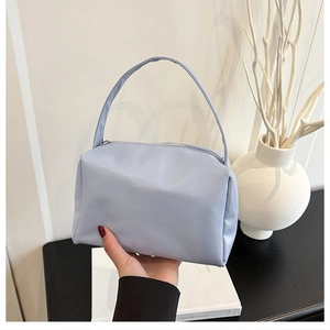 Close-up of light blue nylon cosmetic bag showing smooth texture and zipper closure