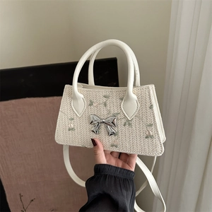 Straw woven crossbody bag with floral embroidery and silver mirror bow detail