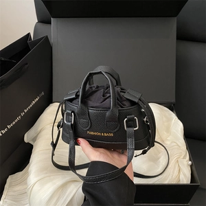 Chic black litchi leather bucket bag with gold lettering and drawstring inner pouch