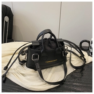 Top view of black mini shell bag with lychee pattern and gold lettering detail