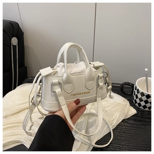 Detail of white lychee pattern leather mini handbag with FASHION & BAGS logo and strap