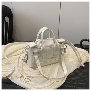 Detailed shot of white mini tote bag with litchi grain leather and drawstring liner