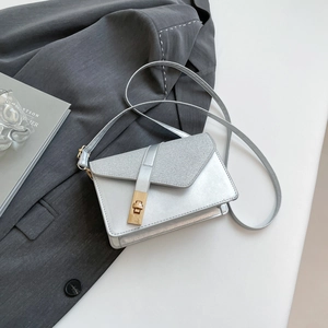Silver metallic rectangular crossbody bag with textured flap and gold rotary lock buckle