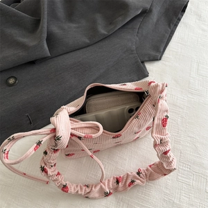 Pink corduroy strawberry shoulder bag with ruffled handle and side bow decoration