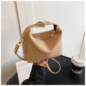 Detail of hand-woven crossbody bag with golden metal buckle and premium texture