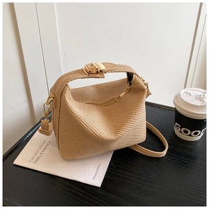 Detail of khaki woven texture handbag with golden clasp and adjustable shoulder strap