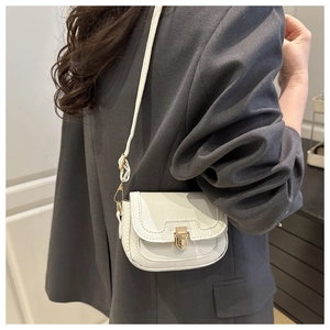 Détail du sac à bandoulière blanc en cuir grainé avec fermoir métallique doré élégant