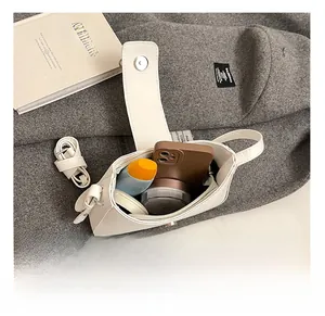 Top view of the spacious interior of this white faux leather bow hobo bag for essentials