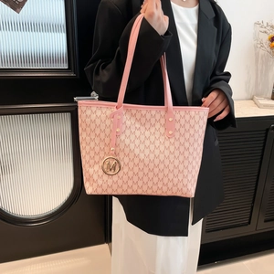 Pink tote bag with M-letter jacquard pattern and golden metallic M-charm pendant