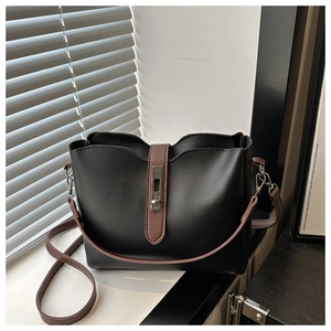 Détail du sac fourre-tout noir et marron avec fermoir pivotant argenté et style vintage