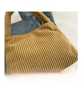 Close-up of yellow corduroy tote bag showing thick ribbed texture and fabric detail