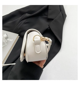 Detailed side view of white PU leather bag showing fine stitching and gold hardware