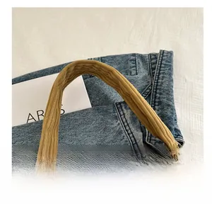 Detail of the corduroy tote bag handle showing high-quality texture and stitching