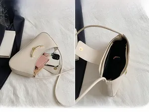 Detail view of cream shoulder bag interior showing capacity for phone and wallet