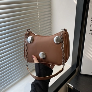 Brown leather crescent moon shoulder bag with silver buckle details and chain strap