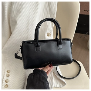 Detail of black rectangular crossbody bag with Fashion logo and detachable strap