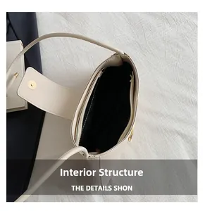 Internal structure of beige leather handbag showing black lining and zipper pocket