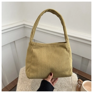 Detailed texture of mustard yellow corduroy shoulder bag with soft ribbed velvet finish