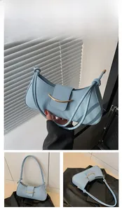 Detail of light blue crescent moon shoulder bag with gold metal buckle and knotted strap