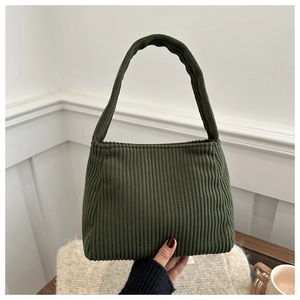 Detailed texture of forest green corduroy fabric on a minimalist tote bag for women
