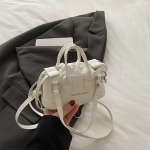 Mini white shell bag in litchi texture with drawstring lining and crossbody strap
