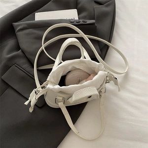 White mini shell bag in litchi grain faux leather with drawstring inner and shoulder strap
