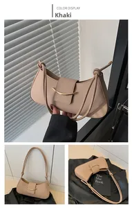 Detail of khaki crescent underarm bag showing knotted shoulder strap and gold buckle