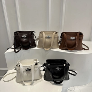 Minimalist faux leather underarm handbags in five classic colors on a white display