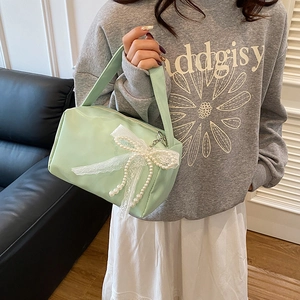 Mint green large capacity vanity bag with lace bow and pearls decoration in hand