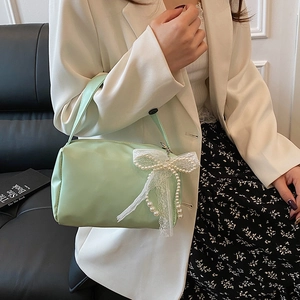 Mint green candy color square handbag with pearl lace bow charm shown on model