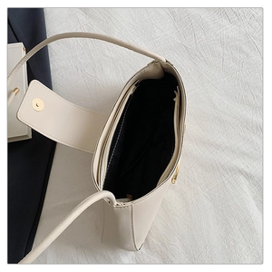 Interior view of off-white shoulder bag showing spacious main compartment and zip pocket