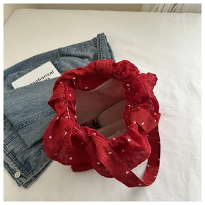 Top view of red floral chiffon handbag showing interior space with pink wallet