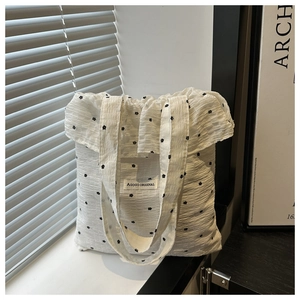 Detail of floral chiffon tote bag featuring ruffled edges and textured bubble fabric