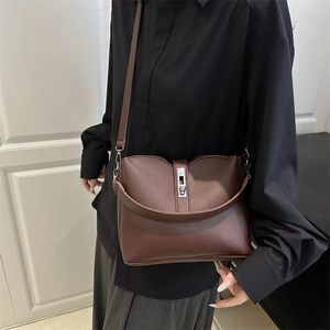 Retro coffee brown bucket bag with adjustable crossbody strap and silver metal clasp