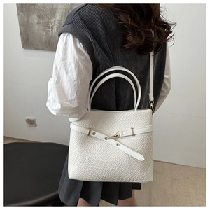 Détail de la texture croco blanc et boucle en métal sur le sac cabas minimaliste