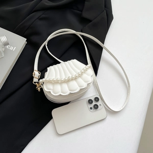 White shell shaped crossbody bag with pearl handle and golden hardware detail