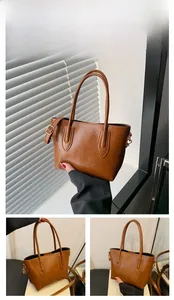 Detail view of brown faux leather tote bag with sturdy handles and adjustable strap