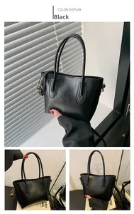 Detailed views showing the bottom and side profile of the black minimalist tote bag