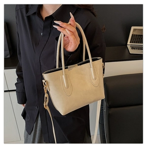 Detail view of large minimalist cream white tote bag with elegant handles and fine stitching