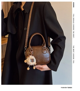 Détail du sac bowling vintage en cuir PU marron avec relief et breloque agneau doux