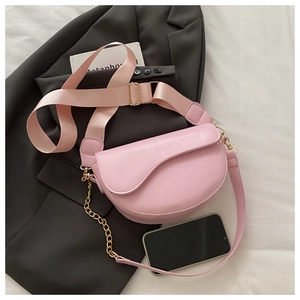 Pink saddle bag featuring matte PU leather with wide fabric strap and gold chain detail