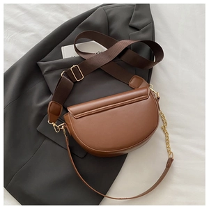 Brown semi-circle saddle bag with wide nylon strap and fine gold chain detail